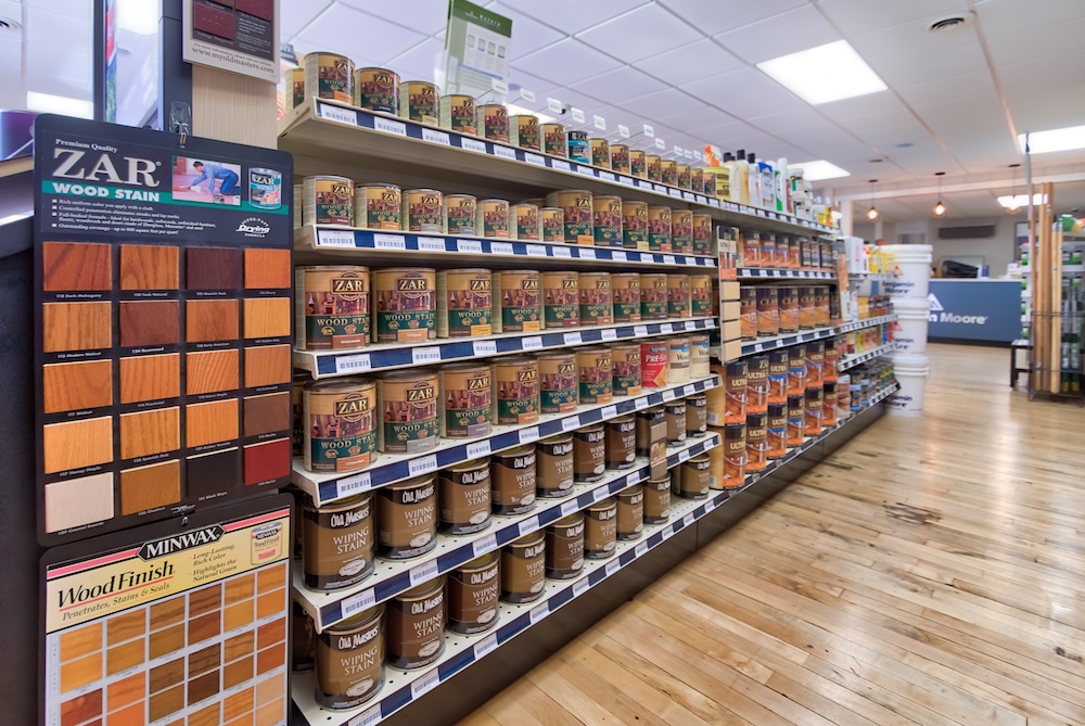 Wood stain products on the shelf inside a Grauer's store.